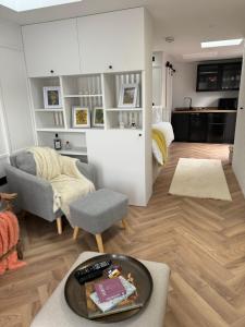 a living room with a couch and a chair at Pleasant Place in Lowestoft