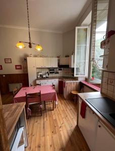a kitchen with a table with a red table cloth at Appartement Eaux-Bonnes in Eaux-Bonnes
