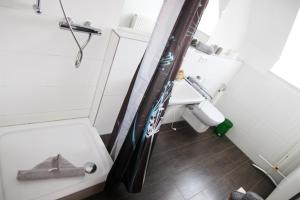 a small bathroom with a toilet and a sink at Haus Rena am Südstrand in Borkum +11 photos