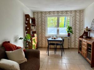 a living room with a table and a window at Petit Havre in Namur