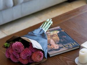a book and a bouquet of flowers on a table at Dawn Mountains Farm in Simondium