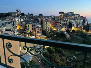 a view of a city from a balcony at Isola Apartment with terrace and Stunning sea view in Corniglia