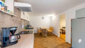 a kitchen and dining room with a table and a refrigerator at Große Ferienwohnung mitten in Bad Belzig in Bad Belzig
