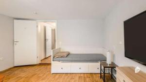 a bedroom with a bed and a flat screen tv at Große Ferienwohnung mitten in Bad Belzig in Bad Belzig
