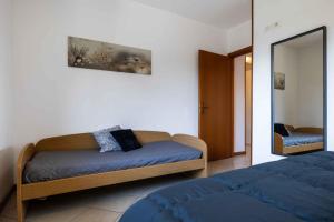 a bedroom with a bed and a mirror at Apartment in Tremosine - Gardasee 22253 in Tremosine Sul Garda