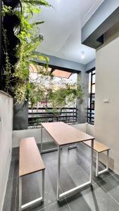 a table and benches in a room with plants at Bangketa Apartments in Antipolo +15 photos