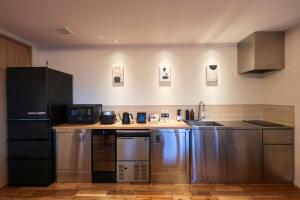 a kitchen with stainless steel appliances in a room at Wellリゾート富士 in Gotemba