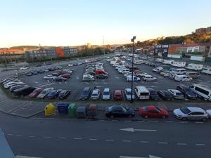 an aerial view of a parking lot with cars at Puente Azud in Avilés