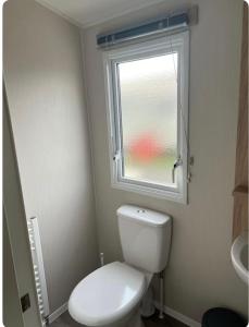 a bathroom with a white toilet and a window at The Edsley in Eyemouth +17 photos