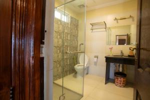 a bathroom with a toilet and a glass shower at Richmond Boutique Hotel in Nathia Gali +74 photos