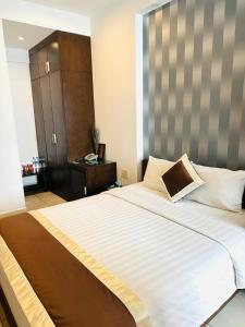 Postel nebo postele na pokoji v ubytování Ngoc Linh Luxury Hotel
