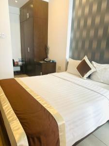 Postel nebo postele na pokoji v ubytování Ngoc Linh Luxury Hotel