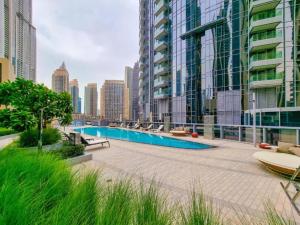 a pool in the middle of a city with tall buildings at Luxurious 1BR in Opera Grand 5 mins walk to Burj Khalifa in Dubai