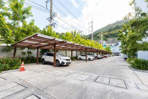 a parking lot with cars parked under a canopy at InterContinental Phuket Resort by IHG in Kamala Beach
