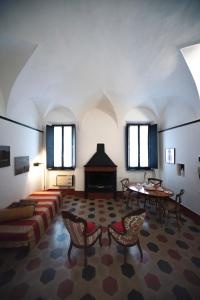 a large living room with a couch and a table at Parma, Antico Studio dietro al Battistero in Parma