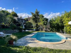 a swimming pool in the backyard of a house at Casa Didun -apart Bartume' in Dolcedo +21 photos