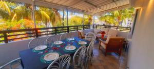 a balcony with a blue table and chairs on a balcony at Spacious and Modern beach apartment in Flic-en-Flac