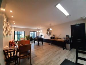 a living room with a dining room and a dining table at Blu Monkey Boutique Bangsaen in Ban Hua Khao Sammuk
