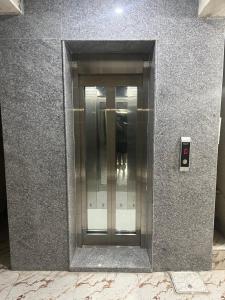 an elevator in the side of a building at Svr guest house in Puttaparthi