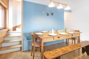 a dining room with a wooden table and chairs at La Perchette - Joli chalet classé 3 étoiles in Chamrousse +13 photos