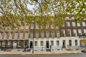 a building on the corner of a street at Cleveland Residences Bloomsbury in London