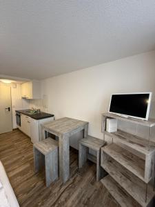 a kitchen with a table and benches in a room at Family Home - 30 in Wilderswil