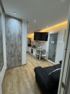 a living room with a couch and a table at Apartamento con patio en Madrid centro in Madrid +24 photos