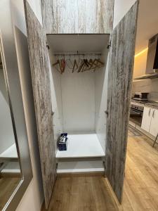 a walk in closet with white walls and wooden floors at Apartamento con patio en Madrid centro in Madrid