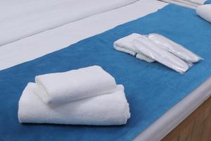 two white towels sitting on a blue cutting board at Resident Hotel in Tashkent +23 photos