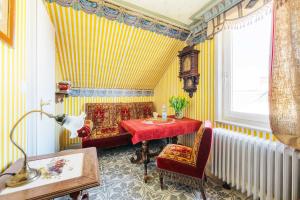 ein Esszimmer mit einem Tisch, Stühlen und gelben Streifen in der Unterkunft Villa Charlotte in Bad Harzburg