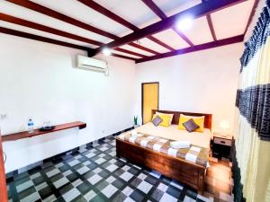 a bedroom with a bed and a checkered floor at HOSTEL KATUNAYAKE At COLOMBO AIRPORT TRANSIT in Katunayake