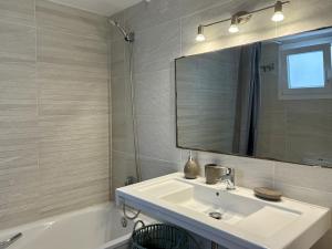 a bathroom with a sink and a mirror and a tub at Villa Son Saura in Cala en Forcat +11 photos