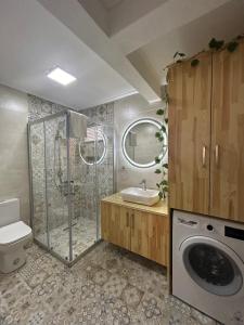 a bathroom with a shower and a washing machine at Urla The Orange House in Kuscular +51 photos
