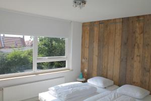 a bedroom with a bed and a window at Spacious house next to the mill! in Westkapelle