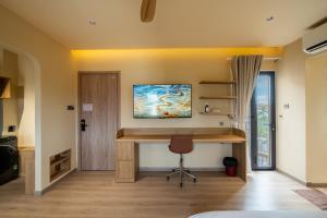 a home office with a desk and a chair at Palmera Hoi An Villa & Apartment in Hoi An