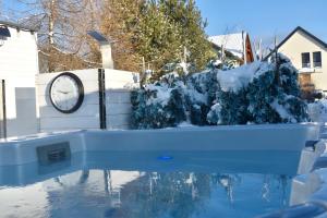 a clock sitting on a wall next to a swimming pool at Serenity in Pribylina