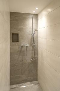 a bathroom with a shower with a glass door at Ferienhaus Anna in Zell am Ziller +46 photos