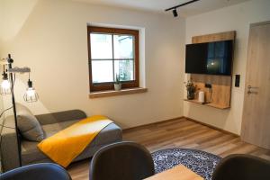 a living room with a couch and a television at Ferienhaus Anna in Zell am Ziller