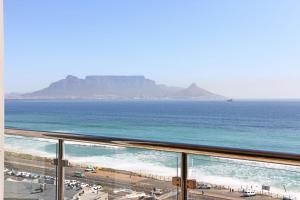 a view of the ocean from the balcony of a condo at 602 Infinity in Bloubergstrand