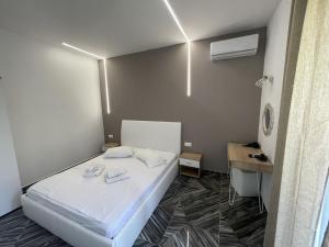 a small room with a white bed and a desk at Christos House in Neos Marmaras +46 photos