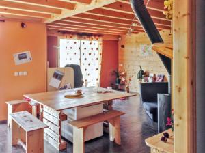 a dining room with a wooden table and chairs at Maison de campagne à Gap avec vue sur la montagne. in La Freissinouse +28 photos