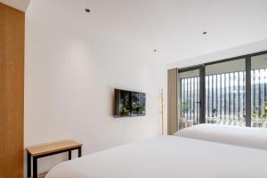 Postel nebo postele na pokoji v ubytování Xi'an Jasmine Boutique Inn