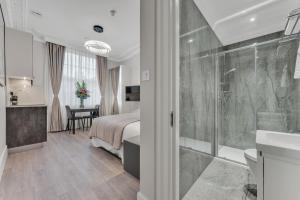 a bedroom with a bed and a bathroom with a shower at Cleveland Residences Bloomsbury in London +279 photos