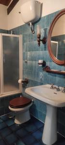 un bagno con un water, un lavandino e uno specchio di La Casetta degli Innamorati a Sutri