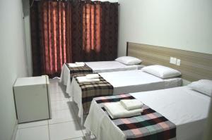 Säng eller sängar i ett rum på Canoas Hotel