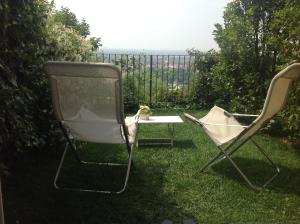 
a lawn chair sitting in the middle of a grassy area at Bed & Breakfast Sant'Erasmo in Bergamo
