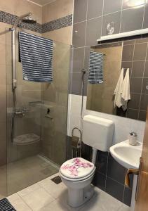 a bathroom with a shower and a toilet and a sink at Murter Inn in Murter +183 photos