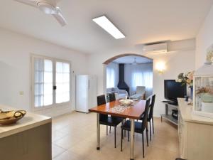 a kitchen and dining room with a table and chairs at Flores in Begur