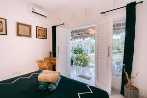 a bedroom with a bed and a sliding glass door at Sukacita Hill in Uluwatu +70 photos
