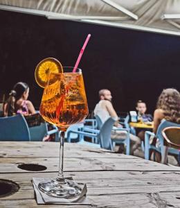 a drink sitting on top of a wooden table at Къщички Синьо лято, Черноморец - Варна - Blue Summer Houses Varna in Varna City +66 photos